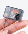 Close-up of SR3100 2.4GHz DSM2 3 Channel Surface Receiver for DX3R DX4C DX5C Transmitters in hand