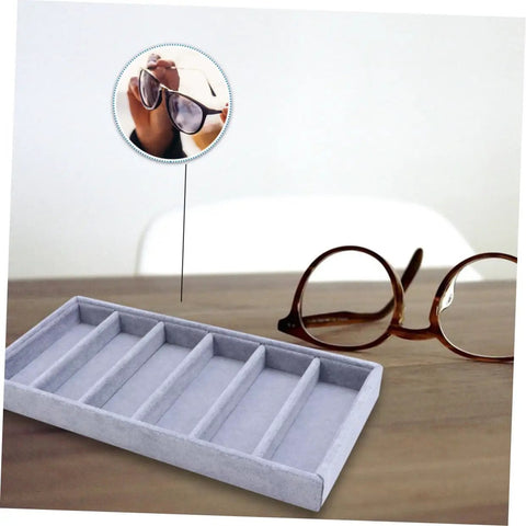 Solid Six Grid Sunglasses Storage Plate And Jewelry Display Box For Women showing grey six compartment organizer on desk with sunglasses.
