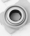Tough As Nails Rock Solid Hex Bearing 210RRB6 One Inch Half X Ninety Millimeter Heavy Duty Replacement For John Deere Farm Tractors, silver hex bearing on a stone background.