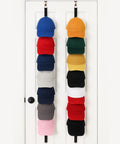 Over The Door Cap Rack Organizer 2 Pack Holds Up To 16 Hats on white door with colorful caps displayed