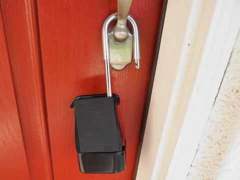 Combo Realtor Lockbox 12 Pack With Easy 4 Digit Code Reset mounted on red door showing robust metal hook and secure high capacity tray