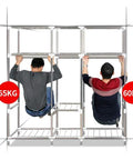 Two men demonstrating strength on a Roomy Portable Canvas Wardrobe Closet Storage Organizer Built Tough With Heavy Duty 25mm Steel Pipes.