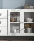 White cabinet with glass doors, wooden shelves, and decorative items, featuring stainless steel cabinet door handles set of 4 with hidden buckle.
