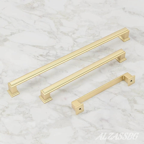 Give Your Home a Chic Glow Up with These Epic Brushed Gold Cabinet Pulls Hardware 10 Pack 5 Inch Handles for Kitchen Cabinets Drawers and Wardrobes Solid Metal Fit displayed in three sizes on marble surface.