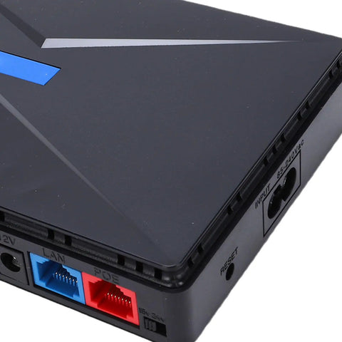 Close-up of Hassle Free Mini UPS Battery Backup For Router And Modem 8800mAh US Plug showing ports and design.