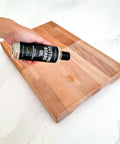 Applying 100 Percent Coconut Derived Cutting Board Oil For Wood And Bamboo Conditioning And Finishing Vegan Mineral Oil Free Non Toxic Sealant For Kitchen Boards No Mess 8 Oz to a wooden board