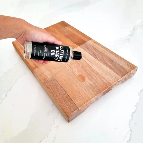 Applying 100 Percent Coconut Derived Cutting Board Oil For Wood And Bamboo Conditioning And Finishing Vegan Mineral Oil Free Non Toxic Sealant For Kitchen Boards No Mess 8 Oz to a wooden board