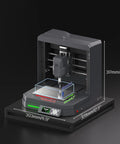 Genmitsu Cubiko desktop CNC router with enclosure; front view showing milling spindle, work bed, and control panel.