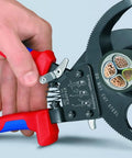 Hand using 95 31 280 SBA Copper And Aluminum Cable Cutters With One Hand Ratchet, showing clean cut on multiple copper wires.