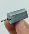 Mini 050 DC Motor 15mm Micro Electric Motor With Precious Metal Brush Runs On 3V 5V 6V Or 9V held between fingers