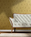 Straight Up Pink Vintage Floral Gold Metallic Wallpaper That Brings Major Style Points To Any Spot With Quick Paste Routine And Sustainable American Made Specs Type I Fire Safe Wallcovering Solid Finish on wall behind a cream sofa.