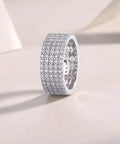 Fresh Drip Platinum Plated Moissanite Grid Engagement Ring Featuring A Smooth Wide Band And Lab Grown Diamond Sparkle Set In Solid Certified 925 Sterling Silver Ring For Her displayed on a light background.