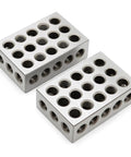 Two silver aluminum BISS calibration blocks with multiple threaded holes on top and sides.