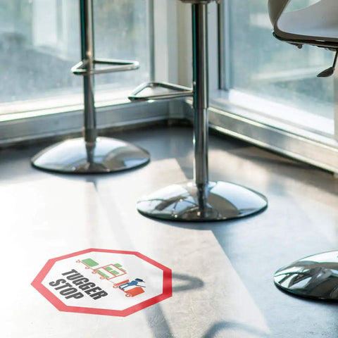 Stop That Tugger Now With These Heavy Duty Red Anti Slip Floor Decals Featuring Tough Round Vinyl Stickers For Warehouses And Factories To Boost Safety And Guide Forklifts Perfectly On Any Surface, octagonal red floor decal with 'Tugger Stop' text