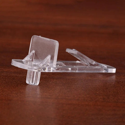 Close-up of a clear plastic shelf peg from a 30 Pack Plastic Shelf Pegs and Clips for Cabinets Deformation Resistant and Easy Install