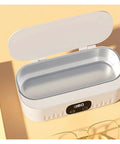 Knockout Portable Ultrasonic Cleaner For Glasses And Jewelry Using High Frequency Vibration And Eco Friendly Deep Wash Tech To Make Your Treasures Look Slick And Sparkling Fresh In Pink, showing open lid and inner basin.