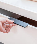 Black 5 Inch Edge Finger Cabinet Pulls Set Of 10 For Kitchen Cabinets And Furniture Doors, being installed on a white drawer.