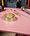 Thin Brass Sheet Roll And Brass Foil For DIY Jewelry Making And Craft Projects With High Thermal Conductivity And Wear Resistance For Mechanical Parts Decorative Projects Garden Crafts And Grounding Uses, coiled brass on pink workbench