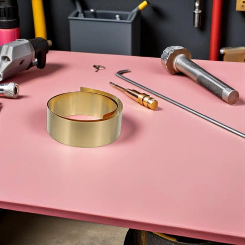 Thin Brass Sheet Roll And Brass Foil For DIY Jewelry Making And Craft Projects With High Thermal Conductivity And Wear Resistance For Mechanical Parts Decorative Projects Garden Crafts And Grounding Uses, coiled brass on pink workbench