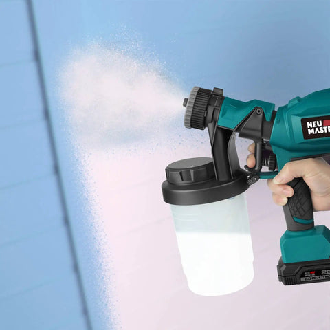 HVLP Electric Paint Sprayer Handheld With 1200ml Detachable Canister painting a blue wall, showing spray pattern.