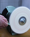 Eight Inch Cotton Buffing Wheel Kit For Bench Grinders And Polishing Tools With Five Eighths Inch Arbor For Hella Smooth Jewelry Glass And Metal Shine Totally Crushes Old Patina Quickly, in use on a bench grinder.