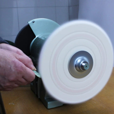 Eight Inch Cotton Buffing Wheel Kit For Bench Grinders And Polishing Tools With Five Eighths Inch Arbor For Hella Smooth Jewelry Glass And Metal Shine Totally Crushes Old Patina Quickly, in use on a bench grinder.