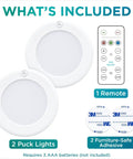 Contents of Stick On LED Puck Lights With Remote, Battery Powered Wireless Cabinet Lighting, 2 Pack, adhesive and remote shown