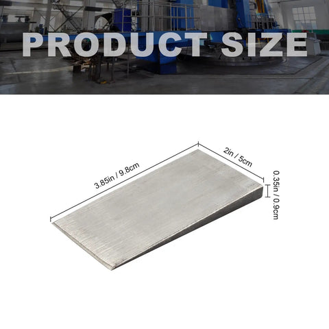 Close-up view of heavy-duty steel flange wedge from six pack, 4 by 2 inch, beveled right angle shim for welding machines and lathes.