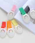 Stick On Cabinet Locks 10 Pack Self Adhesive PP Material Kid Proof Latches in assorted colors displayed on a book.