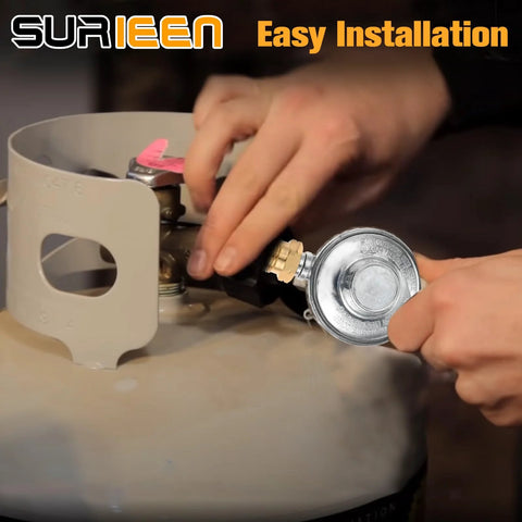 Surieen propane low-pressure regulator with brass fittings being attached to a propane tank