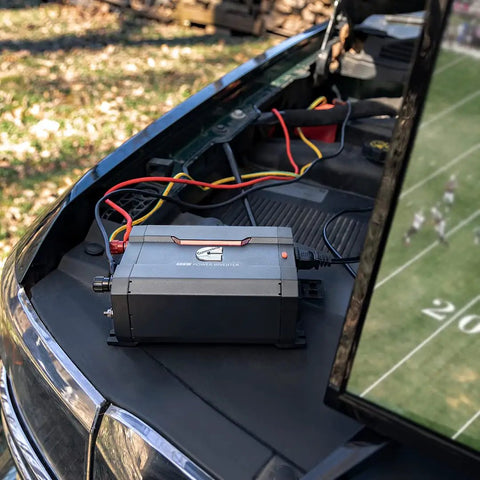 Dope 400 Watt Car Power Inverter Plugs Straight Into Socket To Transform 12 Volts Into 110 Volts AC on car hood.