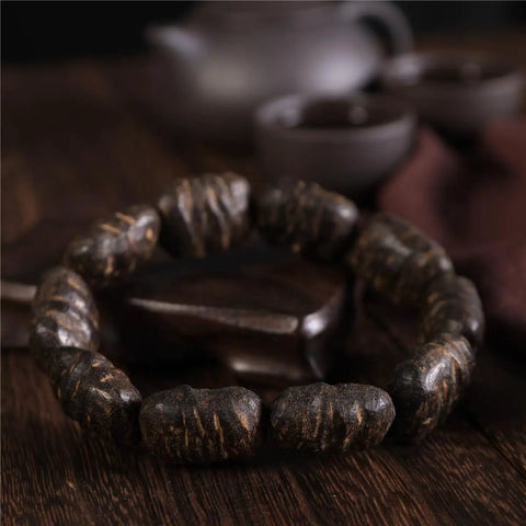 Dope Agarwood Sinensis Jewelry Unisex Adjustable Bracelet with natural burl patterns on wooden beads, dense black oil finish.