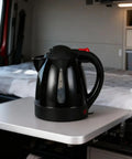 RigReady 24V 250W Portable Electric Kettle For Trucks And Rv placed on a tabletop in a truck interior for convenient access.