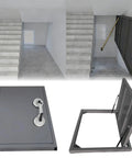 Heavy Duty Recessed Stainless Steel Access Door With Quick Release Suction Handle For Slick Flush Fit Hidden Floor Hatch And Snug Basement Crawl Space Utility Entry Panel In Matte Black, shown in a home entrance.