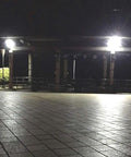 Solid Solar Flood Light With A Kickin Brightness Setup And Zero Sweat Weather Proofing illuminating a tiled patio at night.