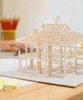 Model house on desk built with ABS Plastic Round Rod 0.5mm By 250mm White For DIY Model Making And Architectural Projects Pack Of 25 Thin Rods.
