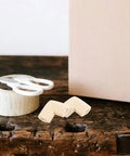 Beige Corner Protectors 20 Pack For Picture Frames, TVs, Mirrors And Fragile Art, Easy No Tool Edge Guards on wooden table