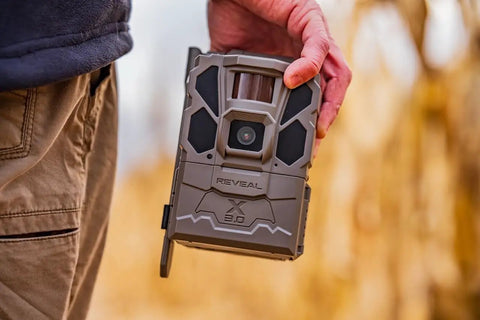 Hella Rugged Cellular LTE Trail Camera With Kick Ass Night Vision And Waterproof Build designed for wildlife tracking held in hand.