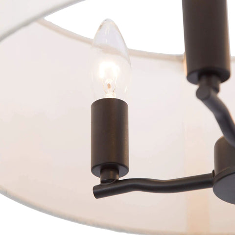 Close-up of Totally Chic Modern Farmhouse Drum Chandelier's candle-style bulb and linen fabric shade, 16 inch diameter.