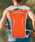 Runner wearing Lightweight Running Hydration Pack with Built In Water Reservoir, Snug Fit Backpack for Runners, in orange.