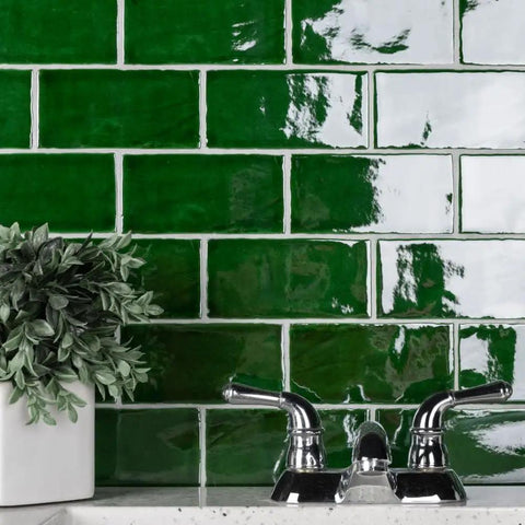 Viva Antic Verde 3x6 Ceramic Wall Tile With Dope Glazed High Sheen Finish shown as kitchen backsplash with faucet and plant.