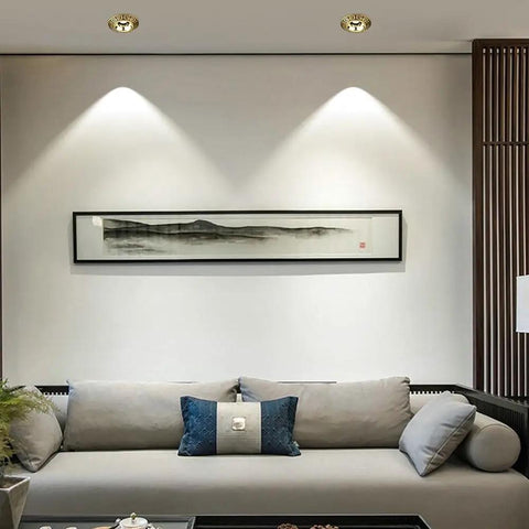 Built Tough 4.3 Inch Adjustable Eyeball Led Recessed Downlight Featuring Solid Brass Housing And Anti Rust Die Cast Baffle Trim For Cool Running Home Fixtures illuminating a modern living room.