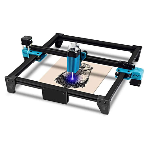 Front view of a desktop laser engraver with black frame and blue accents engraving a wood sheet.