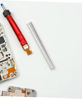Electronic repair tools and components on a white surface including a red screwdriver and an aluminum pipe.