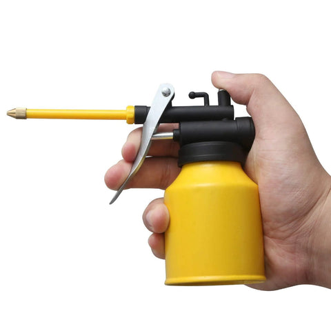 Side view of HUAXIU 8oz yellow metal oil can oiler with black trigger and long spout held in hand