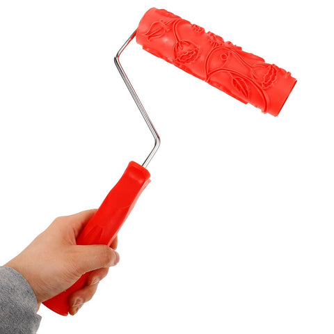 Professional Grade Slick Wood Grain Texture Paint Roller for Interior Wall Decoration held in hand, red rubber grip, embossed pattern.