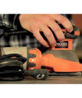 Person using 3 Amp 120V 5 Inch Random Orbit Sander With AirGuard Dust System Pro Grade Variable Speed Dial Permanent Magnet Motor