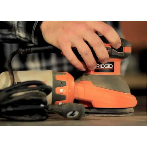 Person using 3 Amp 120V 5 Inch Random Orbit Sander With AirGuard Dust System Pro Grade Variable Speed Dial Permanent Magnet Motor
