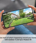Hand holding phone showing live view from Outdoor XR Wireless Security Camera System With Six Cams Two Year Battery Life