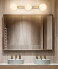 Slick Modern Brass Gold Three Light Vanity Fixture With Milky Glass Shades for bathroom over mirror wall sconce.